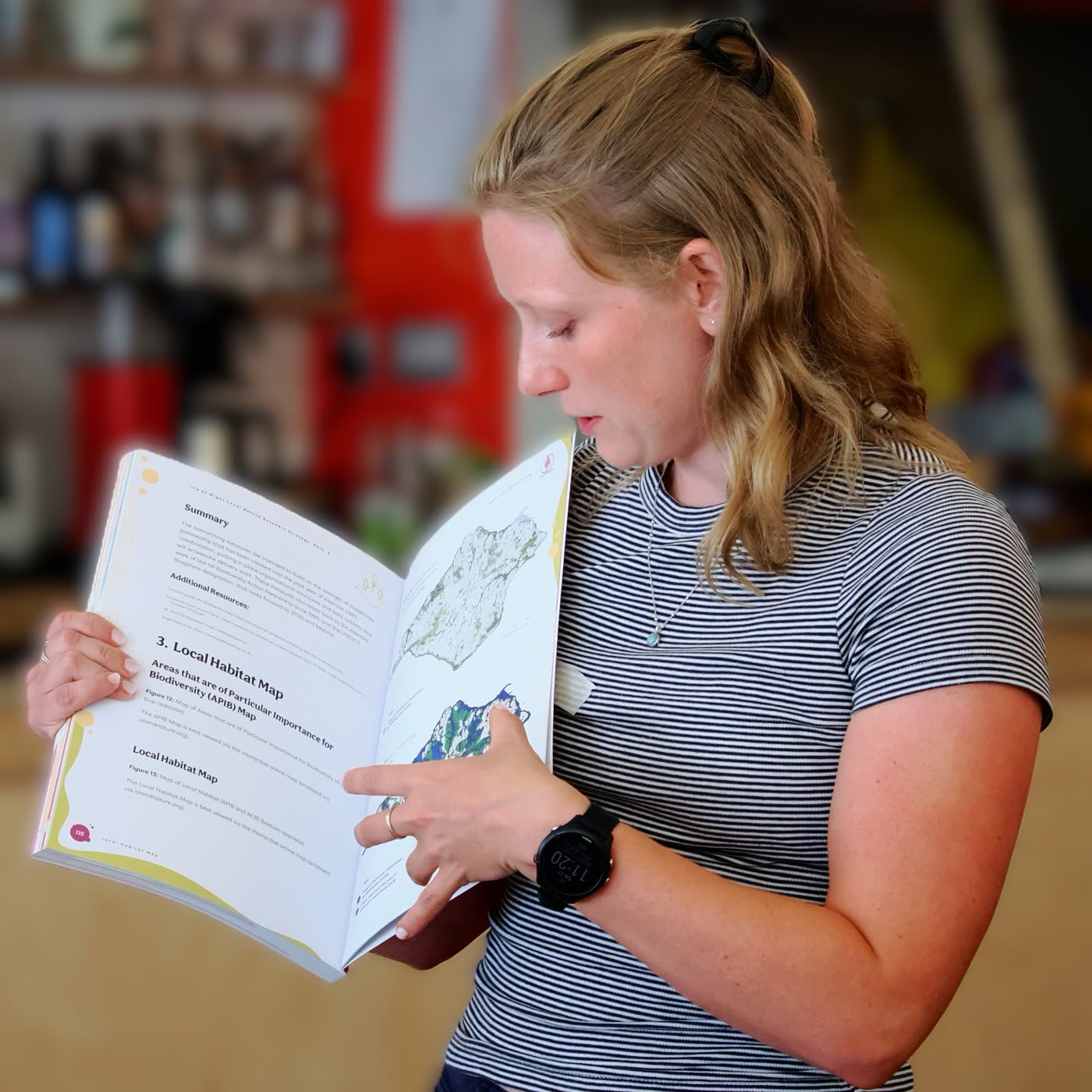 Daneen Cowling reading the local habitat map chapter of the Isle of Wight Local Nature Recovery Strategy
